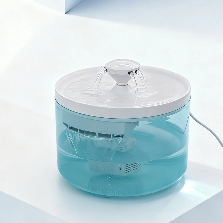 Fontaine d'eau moderne en plastique transparent, couleur turquoise, avec jets d'eau, design élégant.